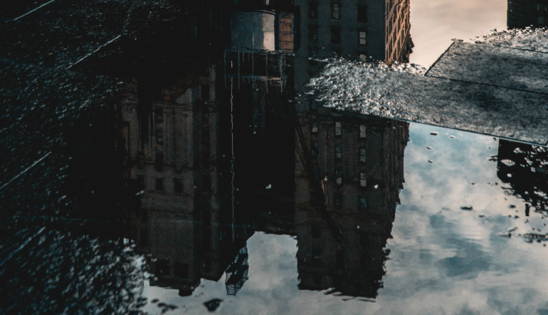 reflection of a building in a puddle