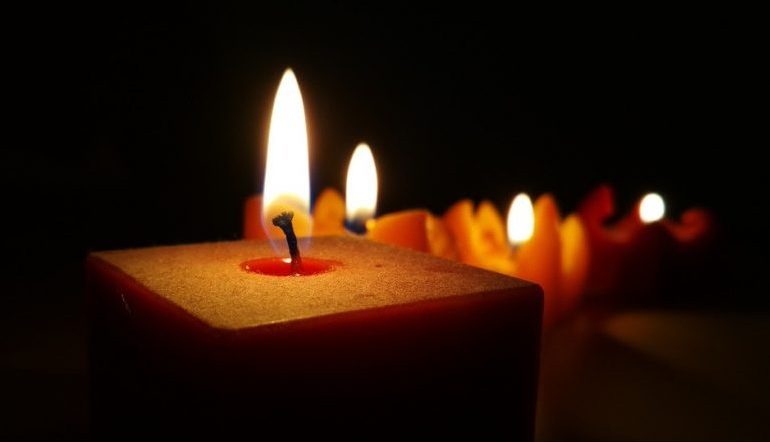 red lit candles against a black background
