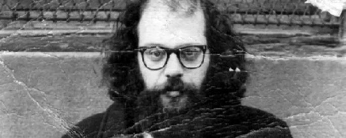 worn, bent, black-and-white photograph of Allen Ginsberg