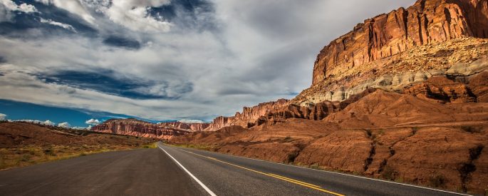 Image of a highway road through red rock canyons.