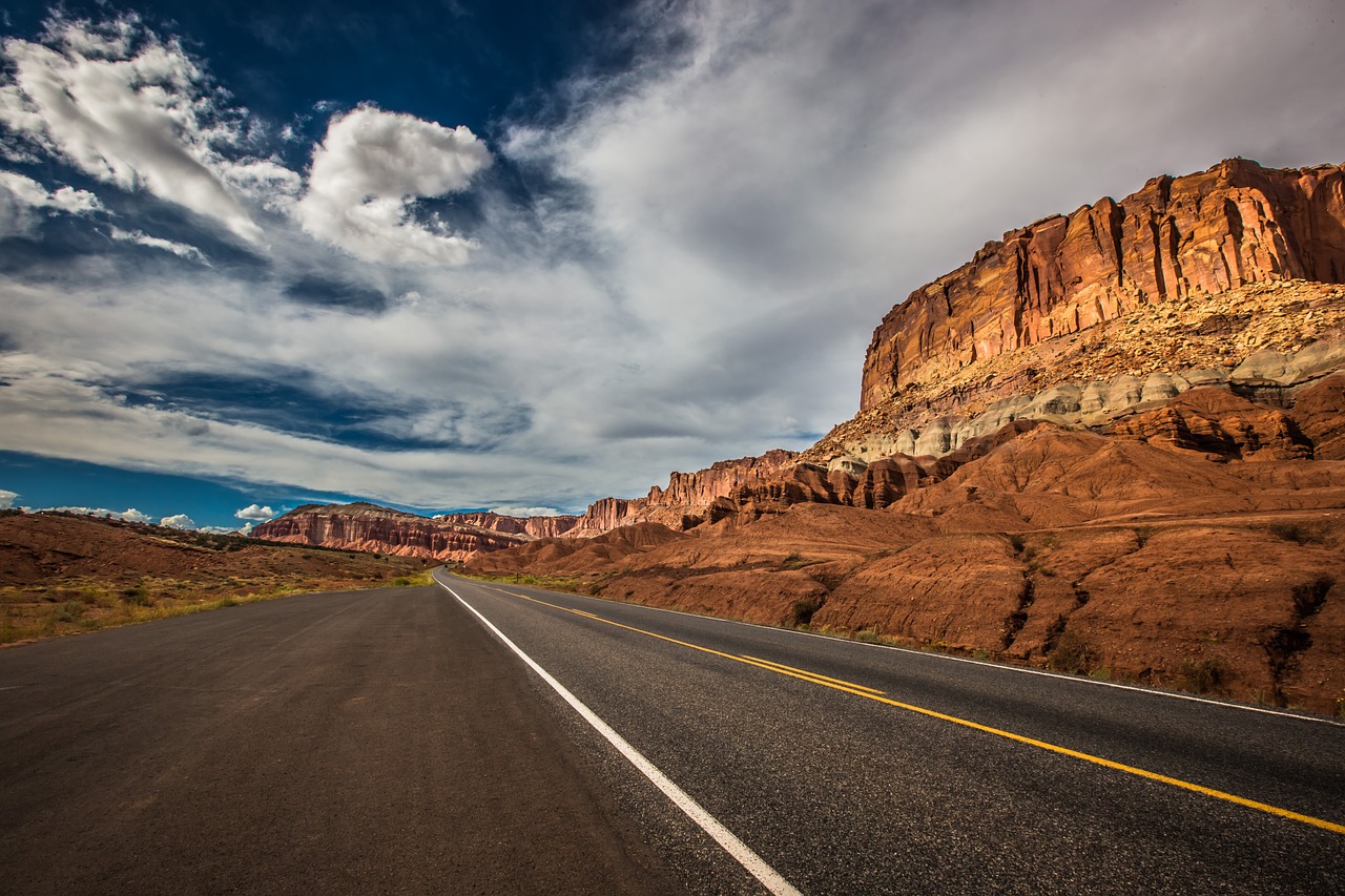 Image of a highway road through red rock canyons.