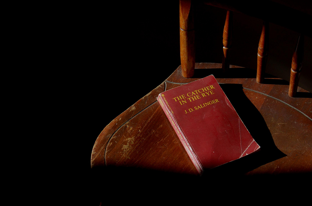 Photograph of an old copy of The Catcher in the Rye laying on an old chair
