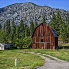 Photograph of a barn and mountains in Montana