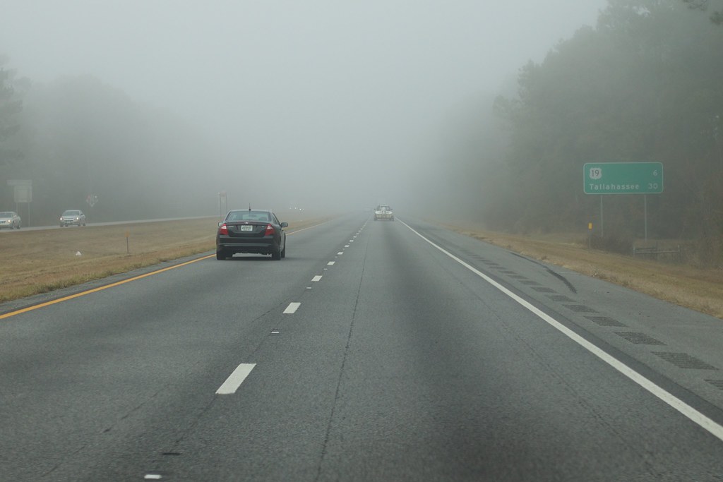 a photograph of a car driving down I-10 in Florida