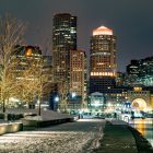 photo of the Boston skyline taken at night in the snow