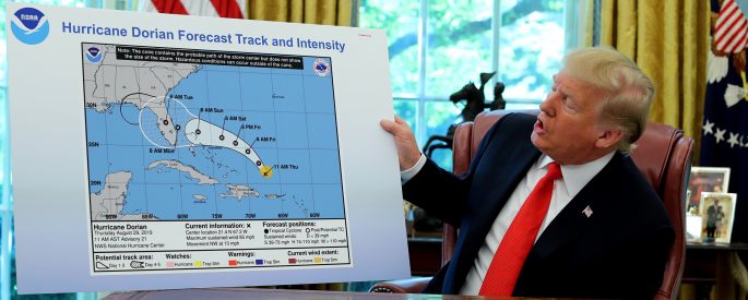 Donald Trump holds up a map of the trajectory of hurricane Dorian