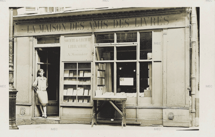 vintage photograph of a woman standing in the doorway of a bookstore