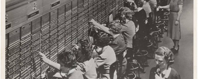 vintage black and white photograph of a line of telephone operators at work